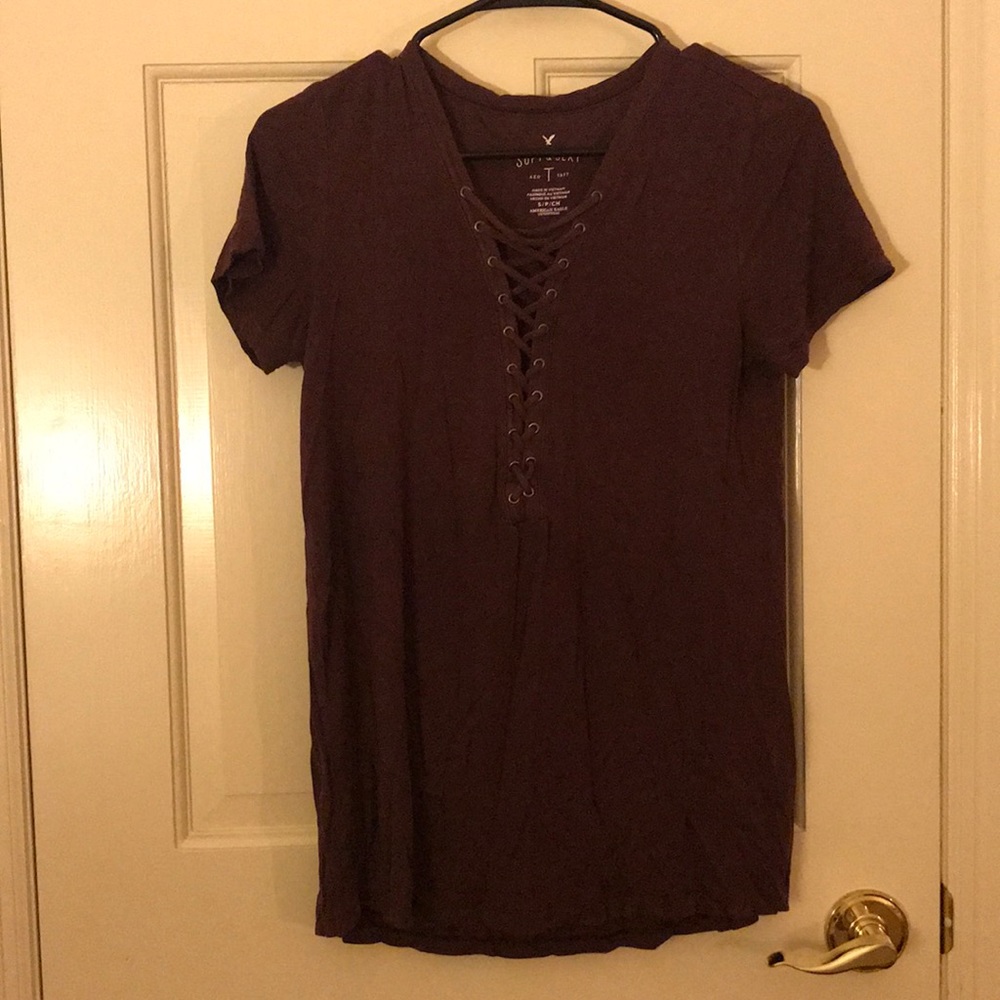 Maroon T-shirt with a crisscross v-neck neckline.